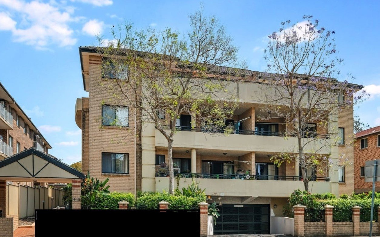 a large apartment building with a large balcony and a garage